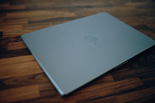 Free Sleek laptop resting on a stylish wooden table, showcasing modern design. Stock Photo