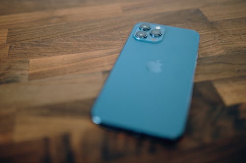 Blue Iphone 11 on Brown Wooden Surface 