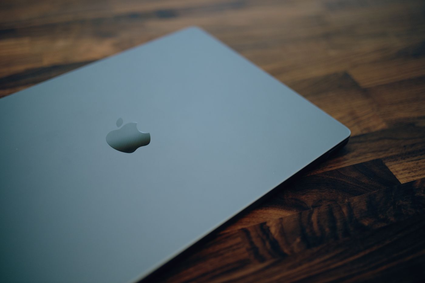 Close-up of a sleek modern laptop with minimalistic design on a wooden table surface.