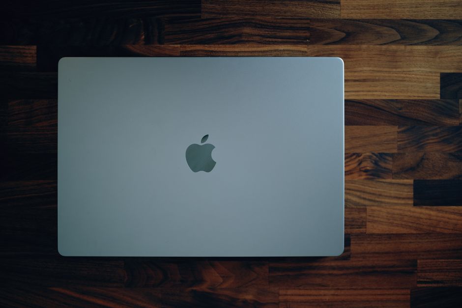 How Apple Watch Fall Detection Supports Elderly Parents Living Alone Sleek MacBook closed on a rich wooden surface, highlighting its minimalist design and modern technology.