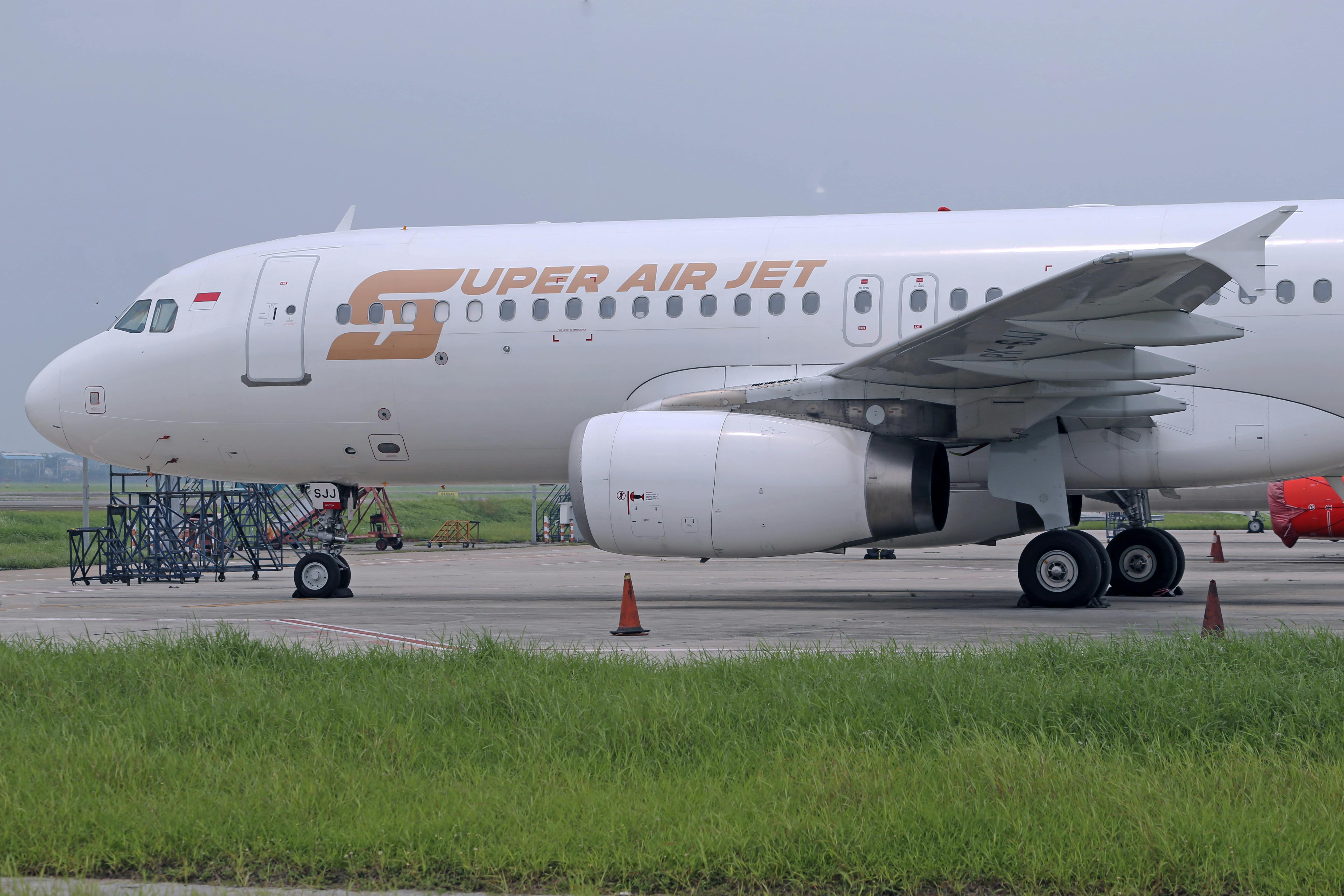 white passenger plane on gray asphalt road