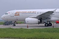 White and Blue Passenger Plane on Gray Asphalt Road