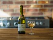 A Glass of White Wine beside a Wine Bottle