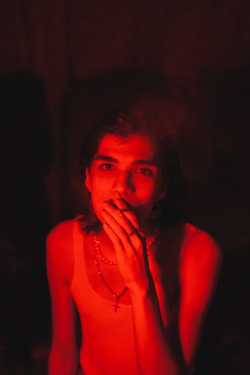 Man with a Cigarette Illuminated by a Red Light