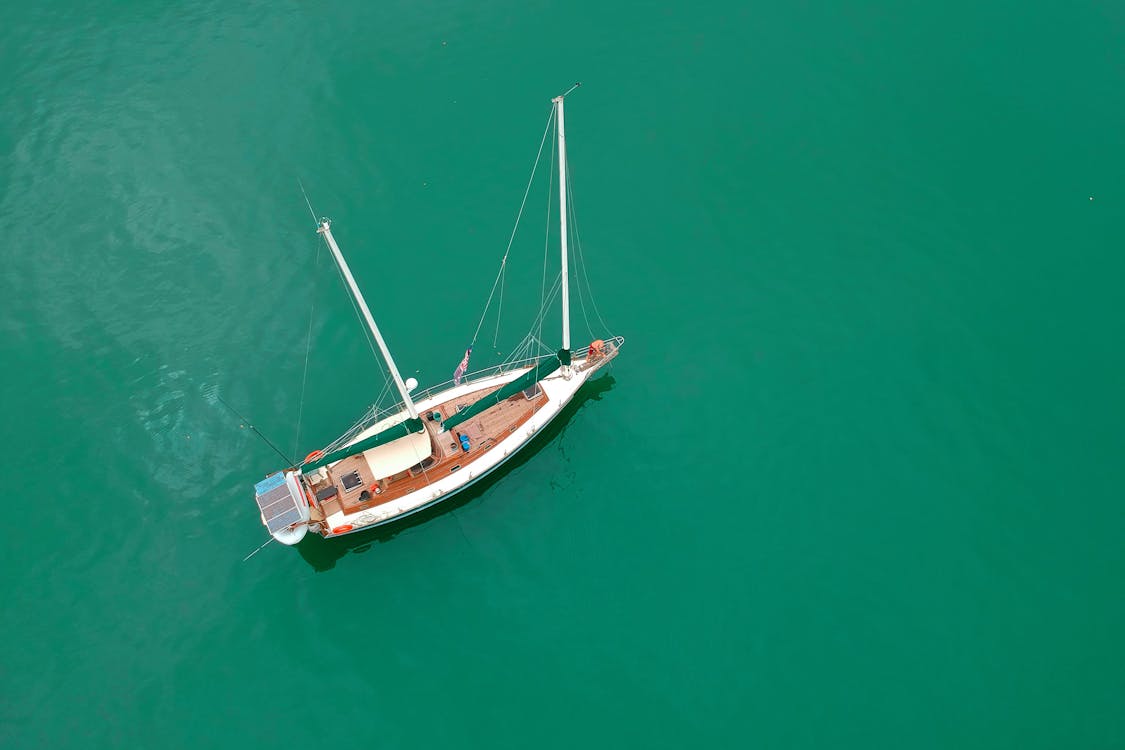 Free White Sailing Boat on Body of Water Stock Photo