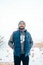 Man in Black Jacket Standing on Snow Covered Ground