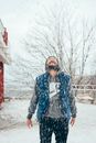 Man in Black and White Jacket Standing on Snow Covered Ground