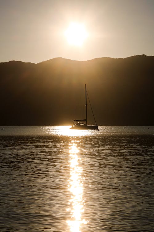 Sailboat on the Sea during Sunset