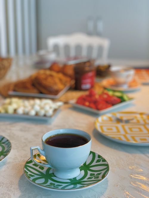 Free Cozy breakfast setting with coffee and fresh pastries on a table set indoors. Perfect for food lovers. Stock Photo