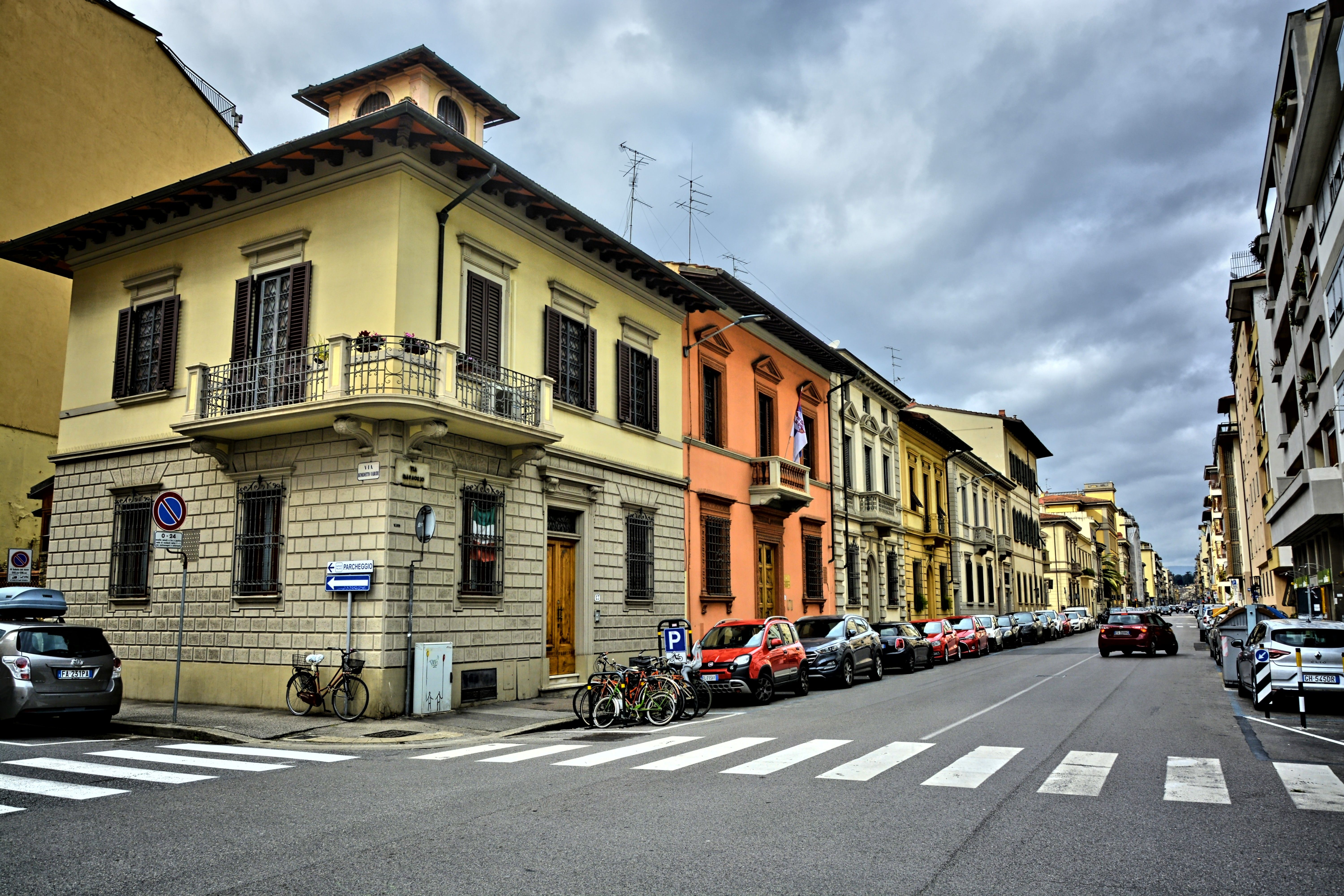 Charming European city street featuring colorful historic buildings and crosswalk.