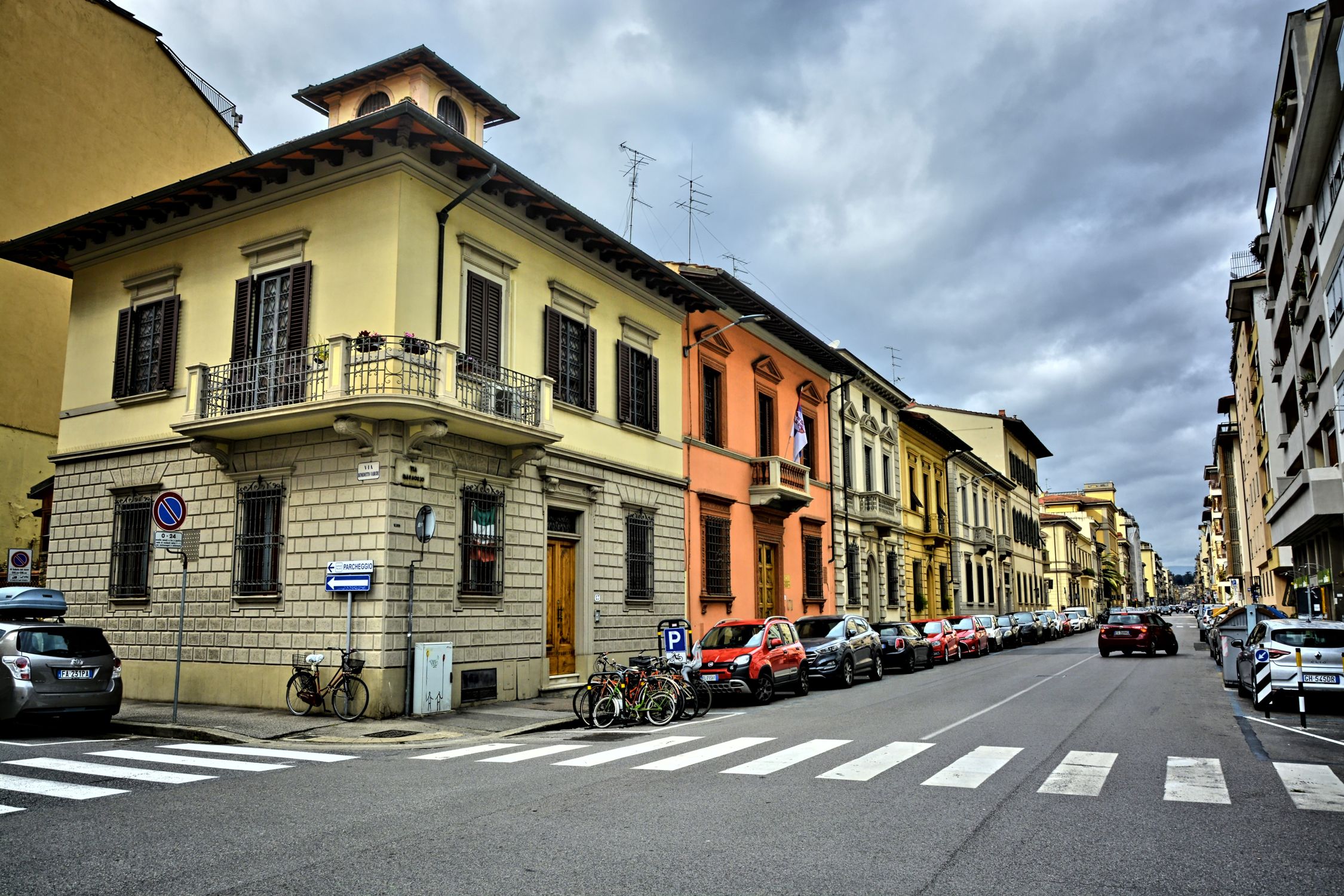 Charming European city street featuring colorful historic buildings and crosswalk.
