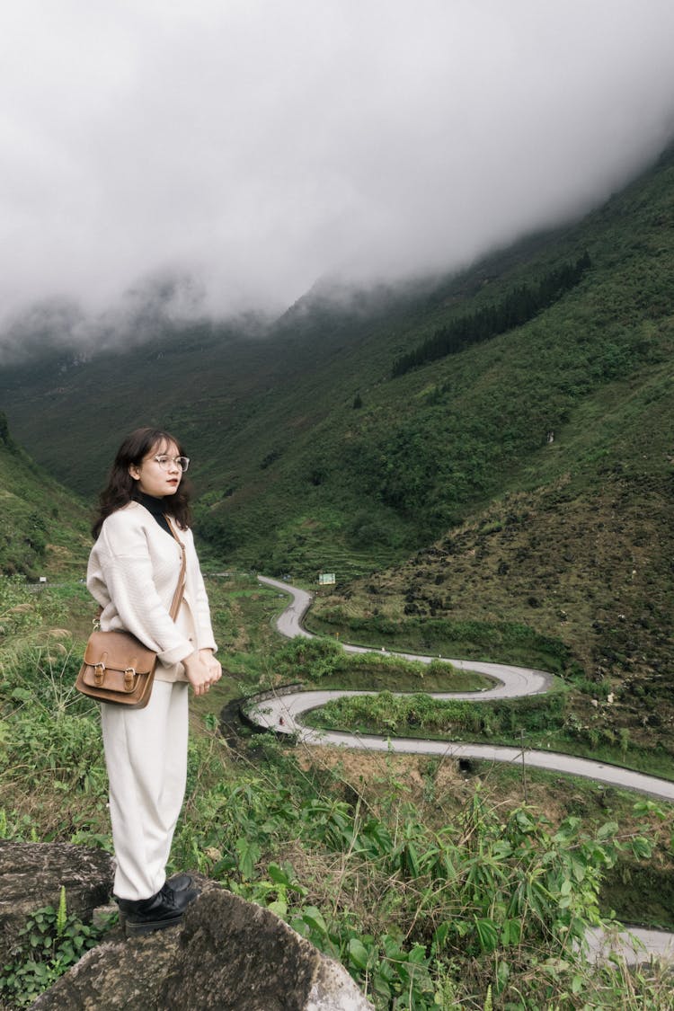 Woman Looking At Serpent Road In Mountain Valley