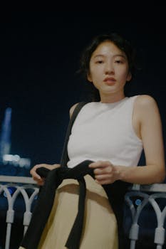 Young woman in Ho Chi Minh City posing gracefully at night.
