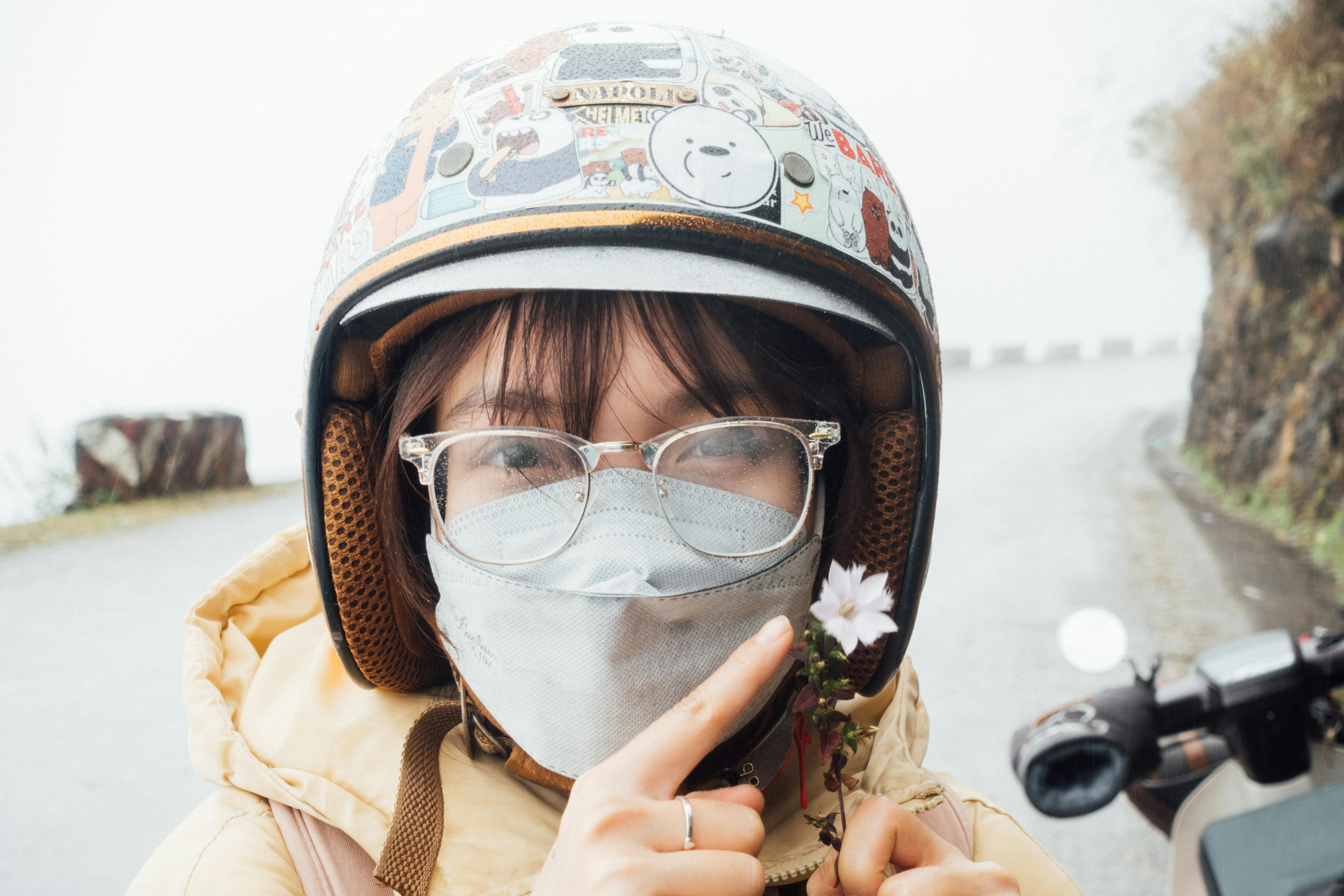 Free A Woman Wearing a Helmet and Face Mask Stock Photo