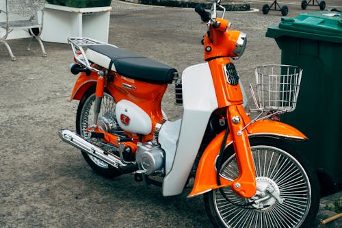 An Orange and White Scooter Parked