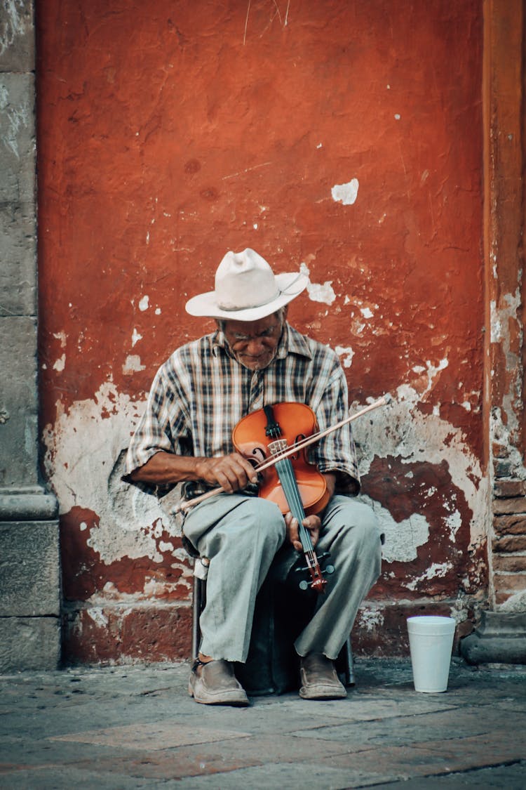 Elderly Man Playing Violin On Street For Money 