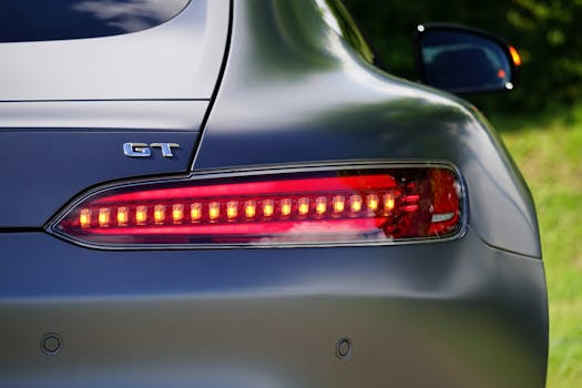 Close-up shot of a GT car tail light highlighting its sleek design and red LED lights.