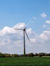 White Wind Turbine Under Blue Sky