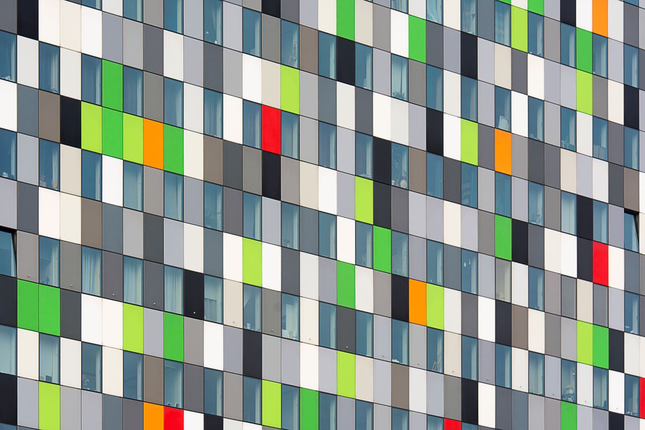 vibrant geometric facade featuring multicolored panels and windows in