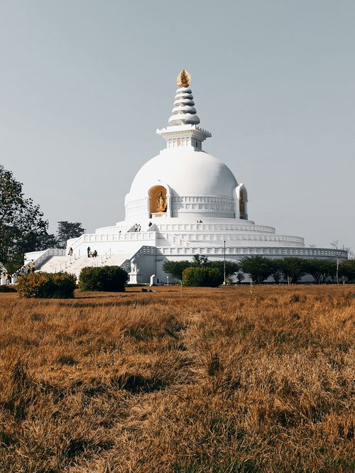Free Discover the serene World Peace Pagoda, a prominent Buddhist monument in Lumbini, Nepal under a clear sky. Stock Photo