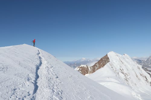 Person in Moutnains under Clear Sky