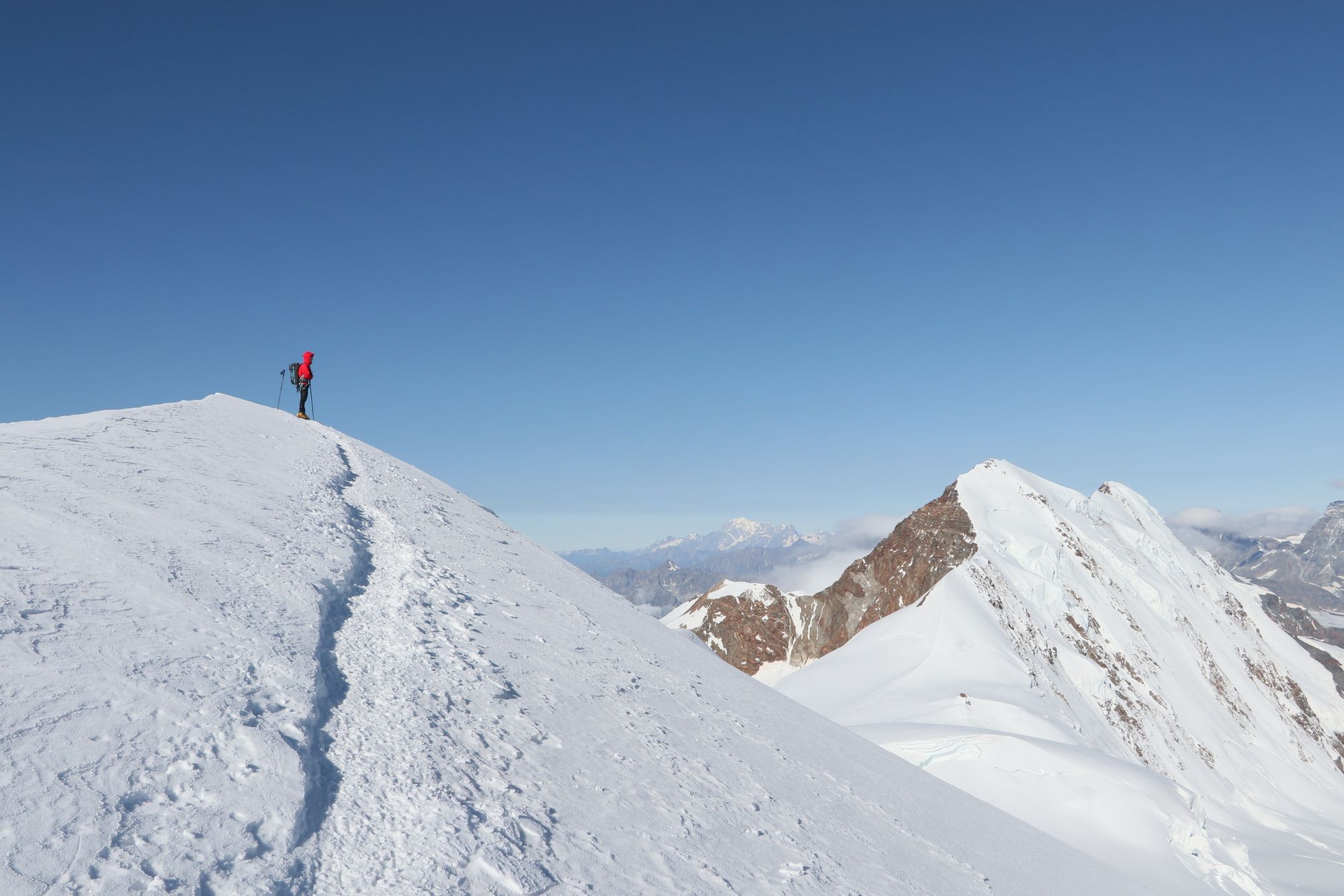 A lone climber on a snow-covered peak