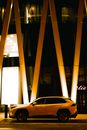 A Yellow Car Parked Beside Yellow Slabs Outside a Building