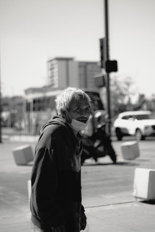 Grayscale Photo of a Man in the Street