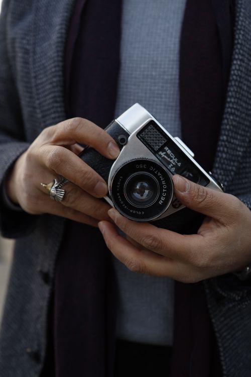 Free Close-up of hands holding a vintage camera with focus on details and texture. Stock Photo
