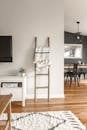 Gray Wooden Ladder on White Painted Wall