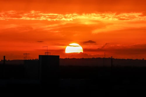 Free A Dramatic Sky During Sunset Over Silhouette of Buildings Stock Photo