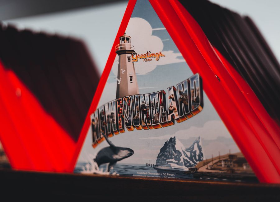 Close-up view of a Newfoundland-themed chocolate box with lighthouse design.