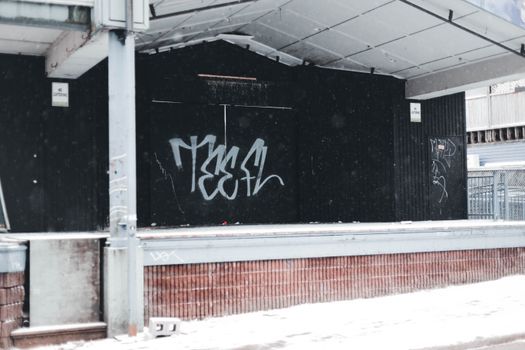 Snow in Front of Doors Covered in Graffiti
