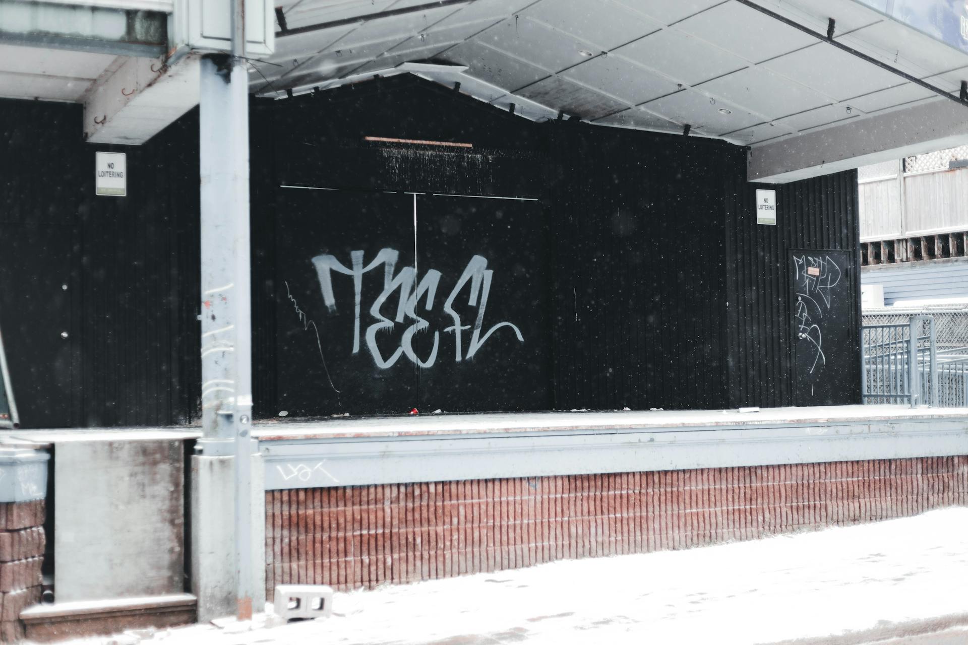 Graffiti-covered urban stage with winter snow, emphasizing a cold, gritty city atmosphere.