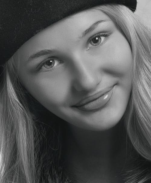 Grayscale Photo of a Smiling Woman 