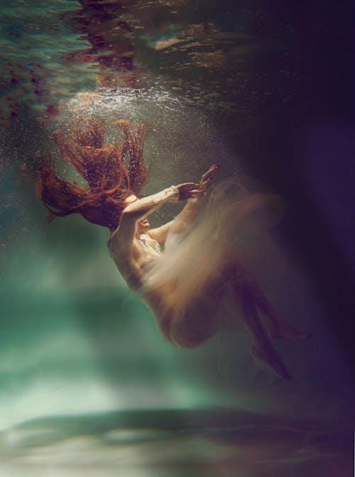 Woman Posing in Dress Underwater 