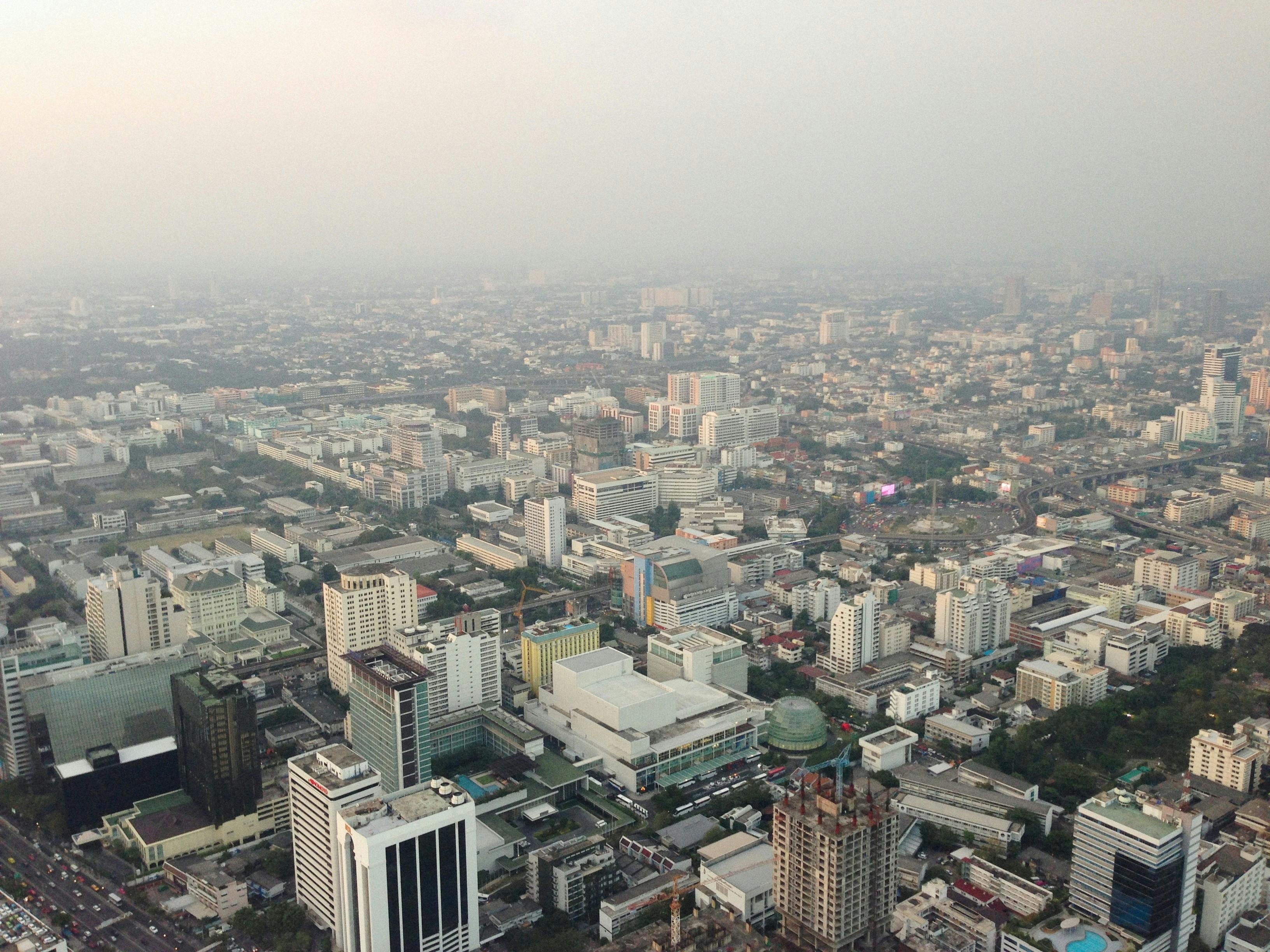Expansive aerial cityscape showcasing an extensive urban skyline under the twilight sky.