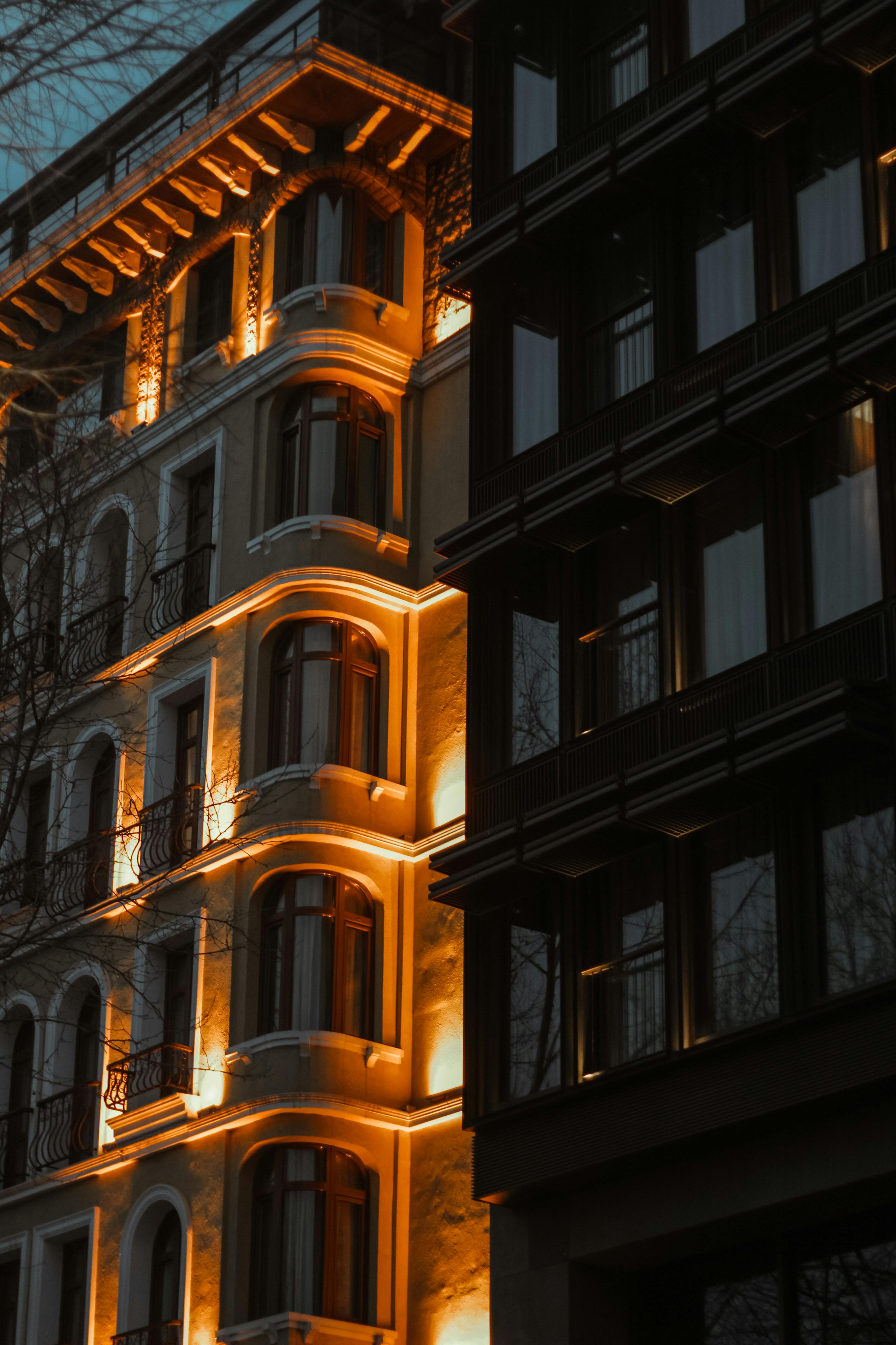 A beautifully illuminated historical building facade in Istanbul at dusk with architectural details highlighted.