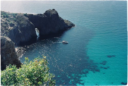 Motorboat near Rocks on Sea Shore