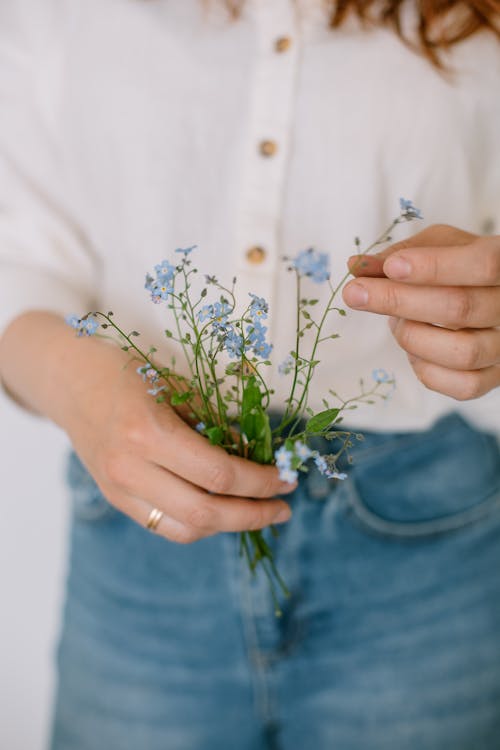 Close-up View of Hands Holding Flowers