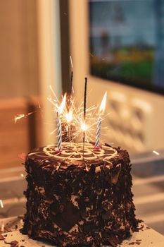 Delicious chocolate cake adorned with sparklers, perfect for a festive celebration.