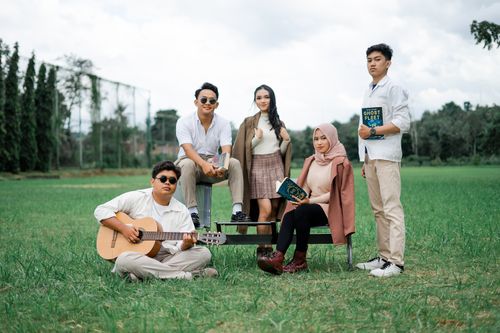 Free Group of People Standing on Green Grass Field Stock Photo