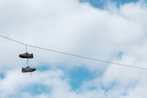 A Pair of Shoes Hanging from a Telephone Wire