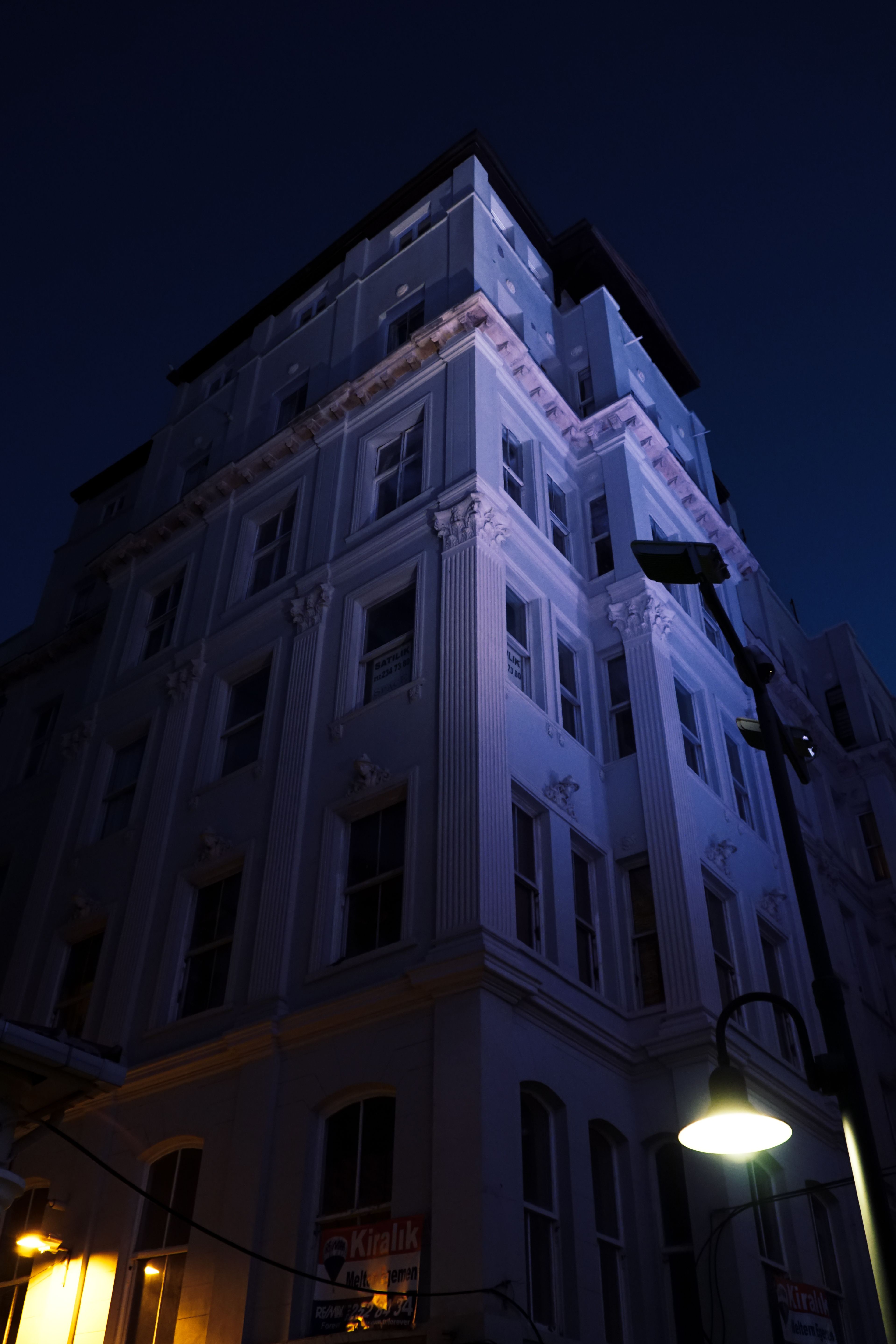 A Cobblestone Street Between Concrete Buildings · Free Stock Photo