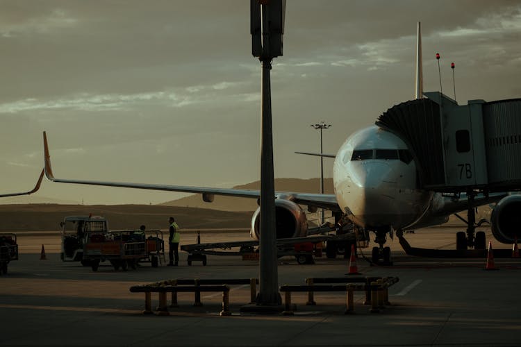 Plane On Airport Field On Sunset