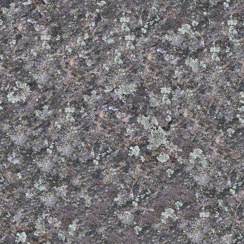 Free Close-up view of a rugged granite rock surface with natural textures and colors. Stock Photo