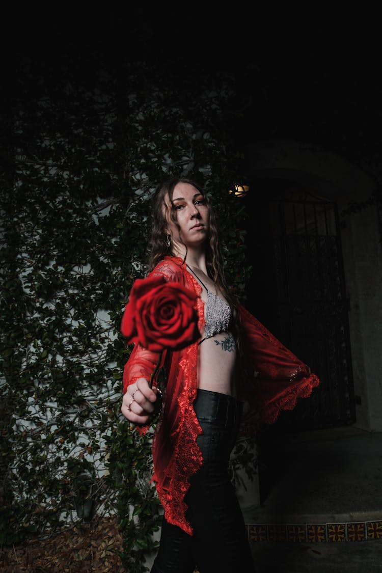 Woman In Red Cover Up Holding A Rose