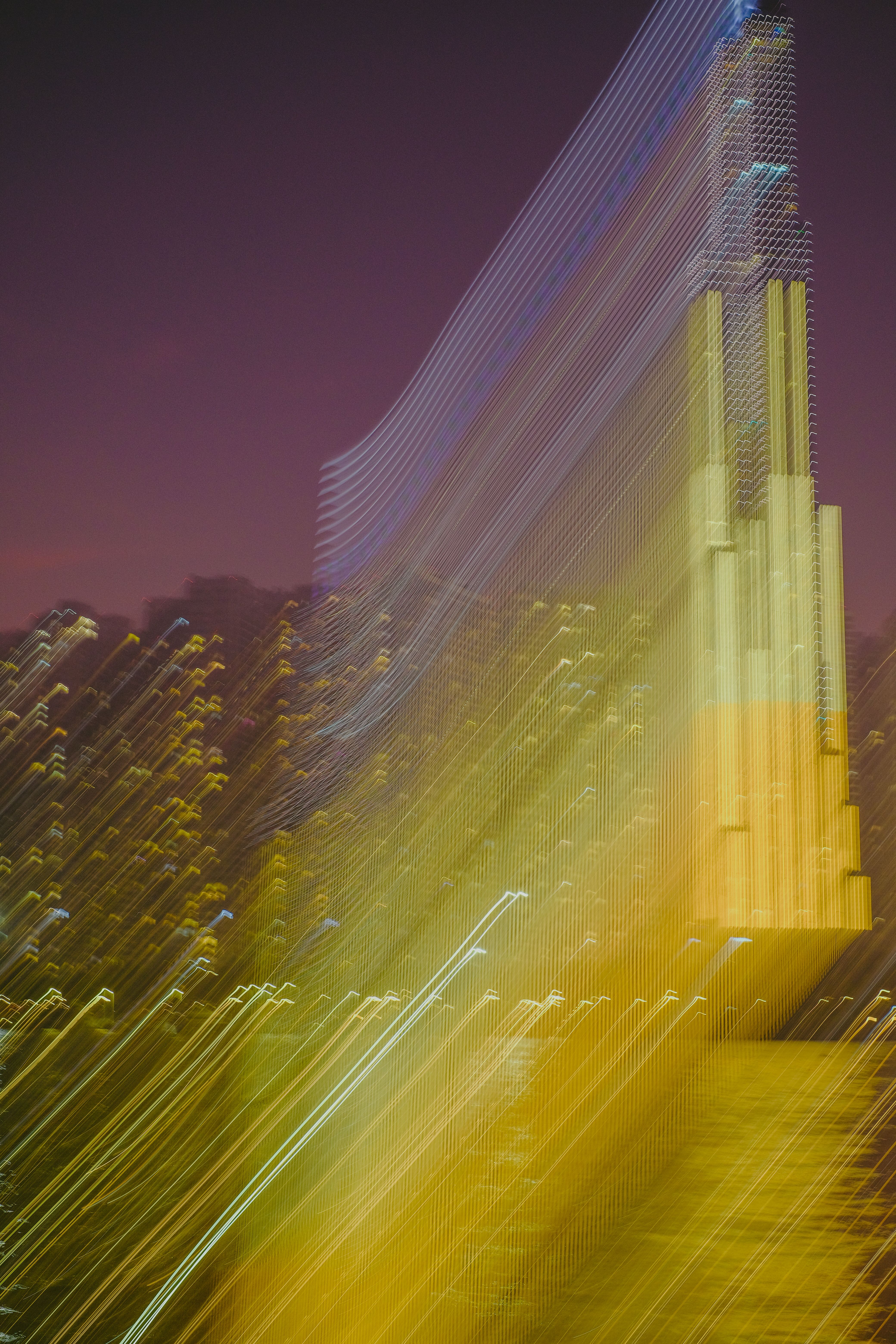 Abstract view of a cityscape with blurred skyscrapers illuminated at twilight.