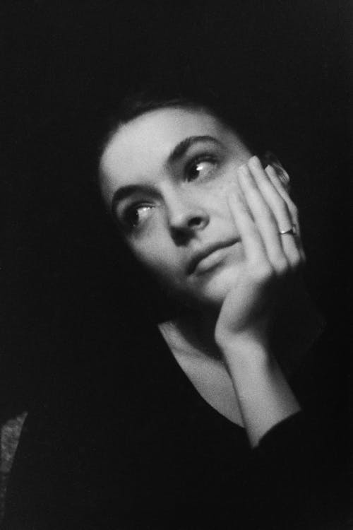 Grayscale Portrait of a Woman with Her Hand on Her Cheek