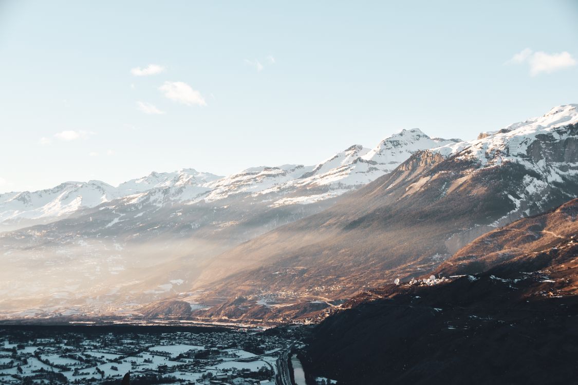 Snow Capped Mountains Under a Blue Sky · Free Stock Photo